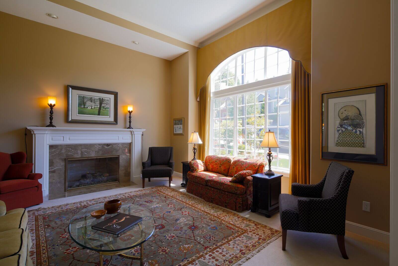 A living room with a fireplace and a soft sofa by the window